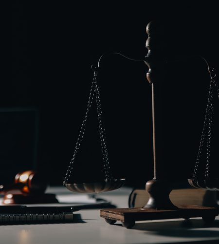 Business and lawyers discussing contract papers with brass scale